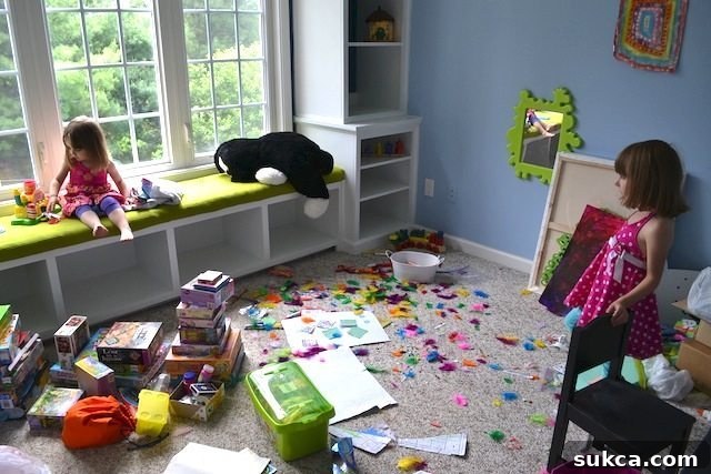 A Lived-in and Loved Playroom The playroom in its natural, 'lived-in' state after an hour of play, demonstrating how the built-ins still manage to provide structure and organization amidst children's activities.