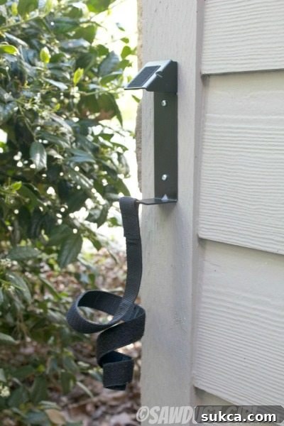 Close-up showing the heavy-duty hook and loop strap of the Scotch Garage Organizer.