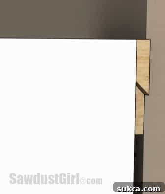 Side view diagram of a French cleat system showing the interlocking beveled edges for hanging a cabinet.