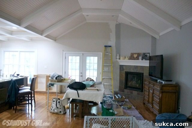 living room with existing oversized fireplace, awaiting renovation and fireplace replacement