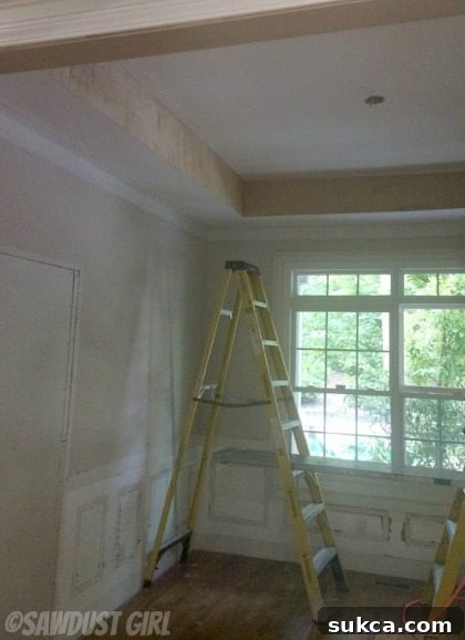 Plywood Overlay for Smooth Beam Surface Attaching 1/4-inch plywood to the existing coffered ceiling, creating a smooth base for faux beams