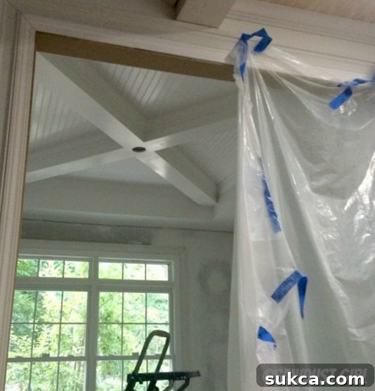 Primed Box Beams and Coffer The primed box beam ceiling, meticulously prepared and ready for the application of a second, contrasting paint color