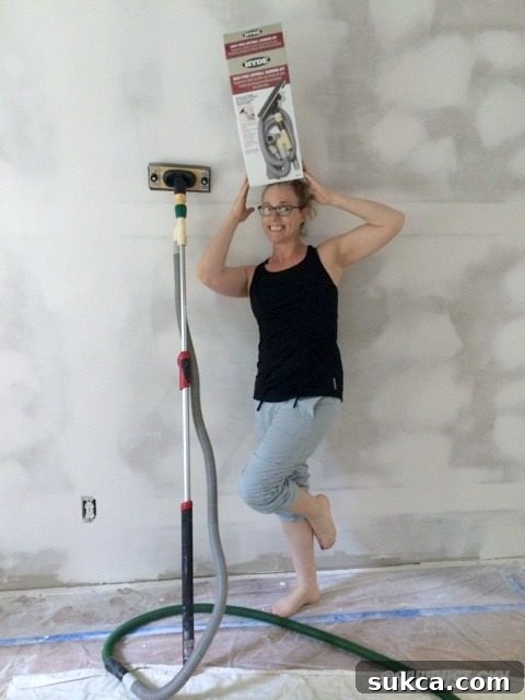 Efficient dust collection with a connected shop vac for clean sanding Close-up of the Hyde Tools Dust-Free Drywall Sander connected to a shop vac hose