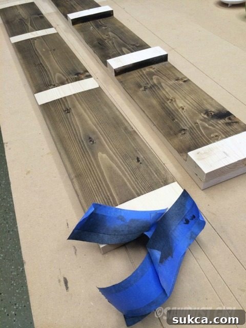 Tape Removal Removing ScotchBlue Painter's Tape after interior finish, revealing clean wood for gluing.