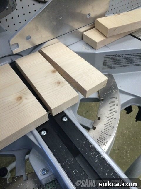 Cutting Pine Blocks Precisely cutting 2-inch pine blocks on a miter saw for the magazine holder project.