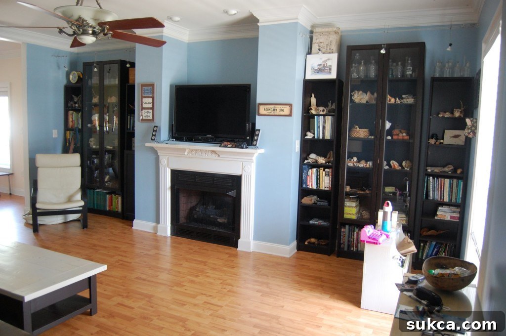 Before photo of an outdated fireplace wall with plain walls