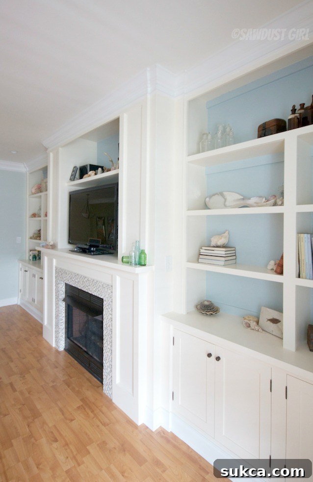 Another perspective of the elegant white built-in units flanking the fireplace, enhancing the living room