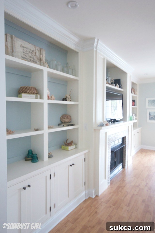 Stylish built-in shelves and cabinets surrounding a fireplace, showcasing organized media and decor