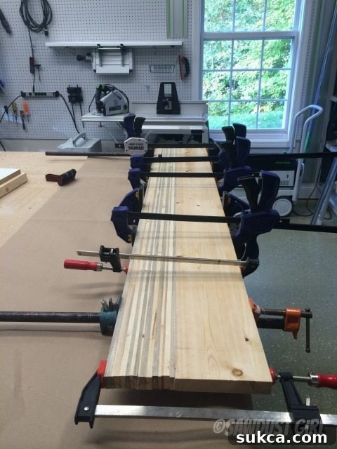 clamps Clamping a wide panel of glued-up wood strips for the table top