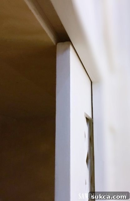 Internal view of the cabinet showing the installed upper cleat for the sliding door