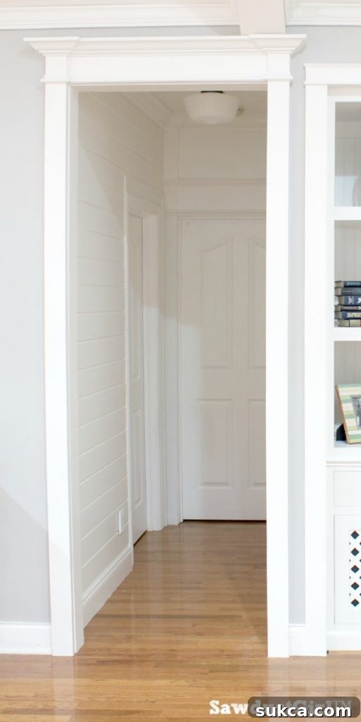 Vertical view of finished hallway trim, showing the seamless integration of molding elements from floor to ceiling.