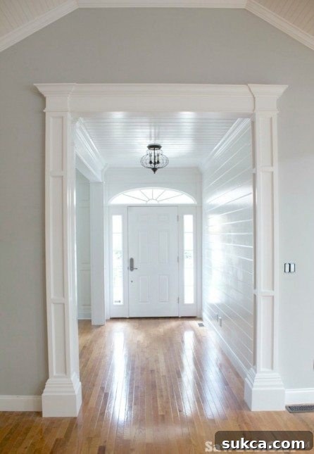 Finished decorative column in a doorway, painted white