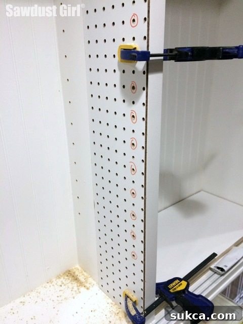 DIY Jig for drilling Shelf Pin Holes, demonstrating use inside an assembled cabinet