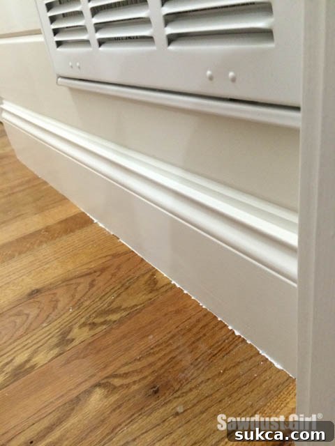 Close-up of stubborn dried paint on a wood floor surface