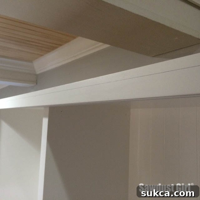 Accurately marking the crown molding line on cabinets.