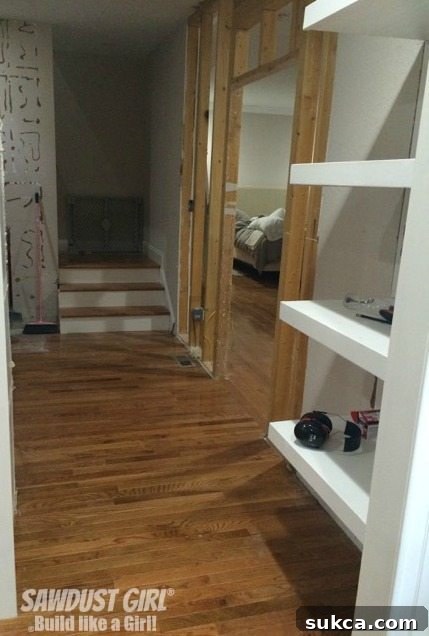 Freshly patched floor where a wall was removed, signifying significant progress in a home renovation and preparing the space for new flooring.