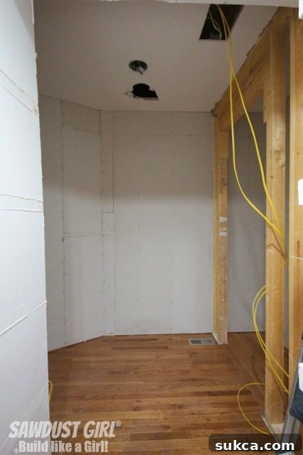 A sweeping interior shot of the newly constructed pantry, revealing its impressive size and potential for optimal kitchen organization.