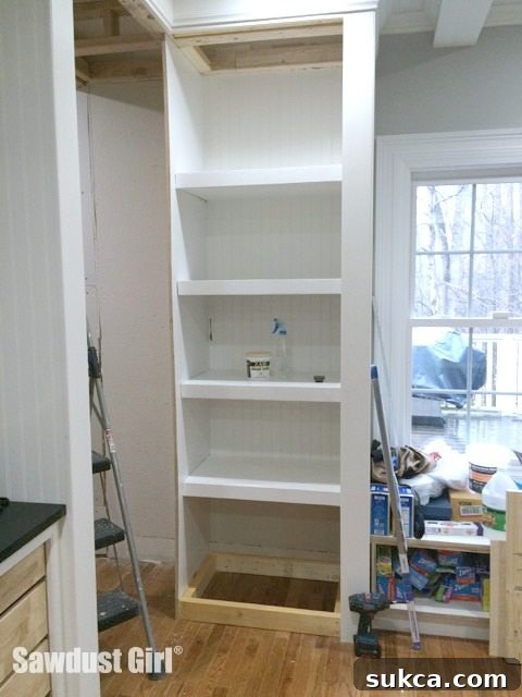 Detailed view of the newly constructed cabinet bottom, prepared for baseboard installation