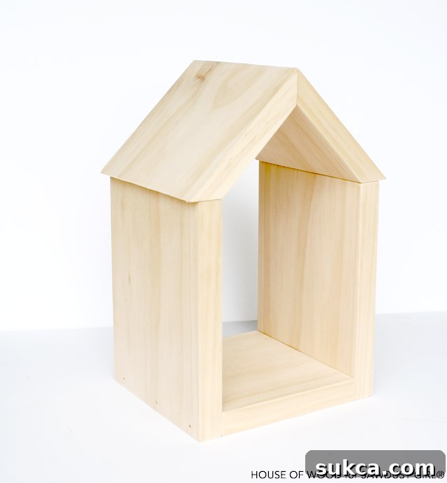 Attaching the beveled roof pieces to the house shelf