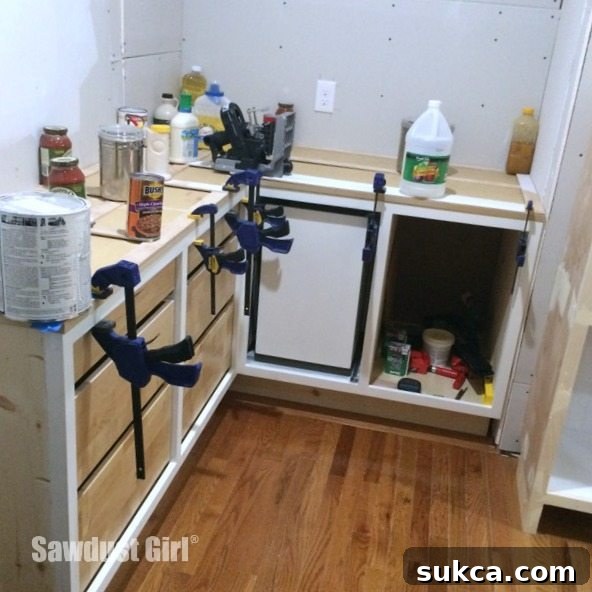 Laying out plywood strips on cabinets to form a countertop template