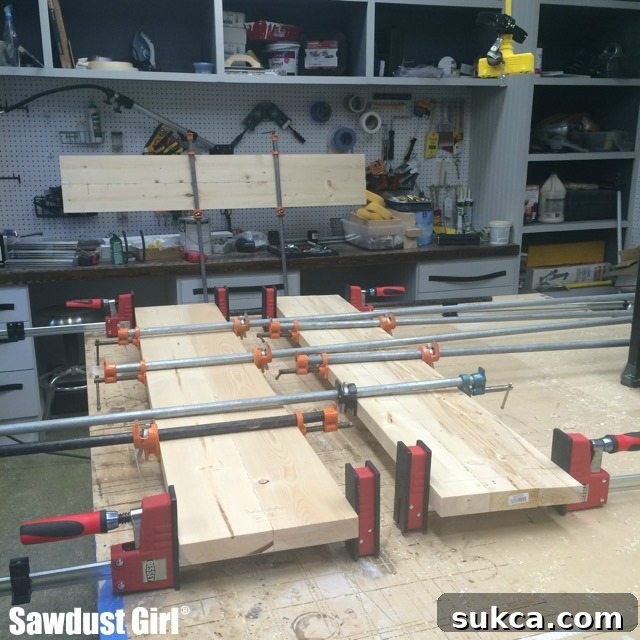 Clamping multiple wood boards together for a countertop section after glue and Domino application.