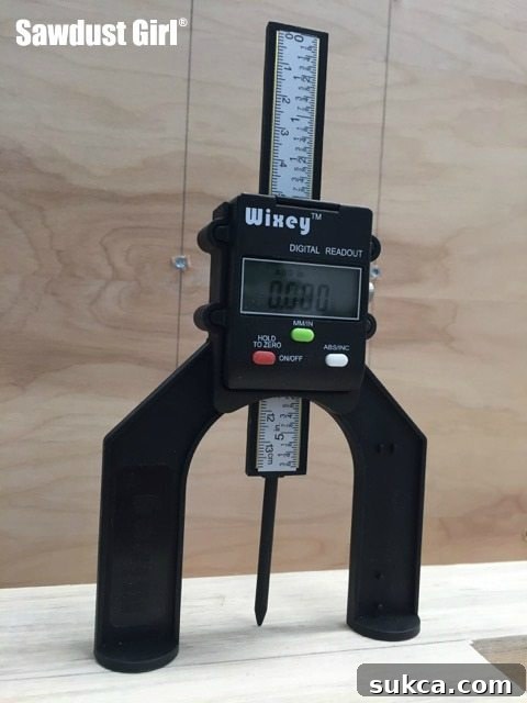 Digital gauge display showing zero reading on surface Zeroing the digital height gauge for depth measurement