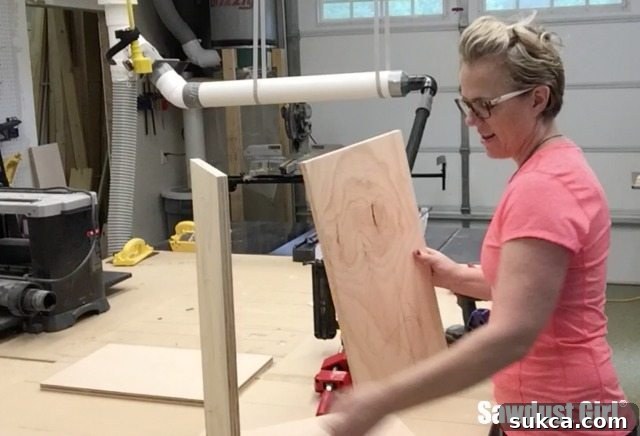 Small upper pantry cabinet being assembled with corner clamps and a nail gun for quick and precise construction.