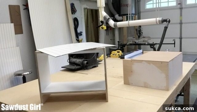 Small cabinet being assembled with a screw gun, highlighting precise joinery and the use of modern woodworking tools.