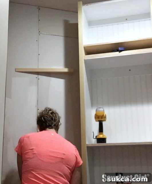 Angled block precisely installed on the wall to support a shallow pantry cabinet, showcasing custom fitting and problem-solving.