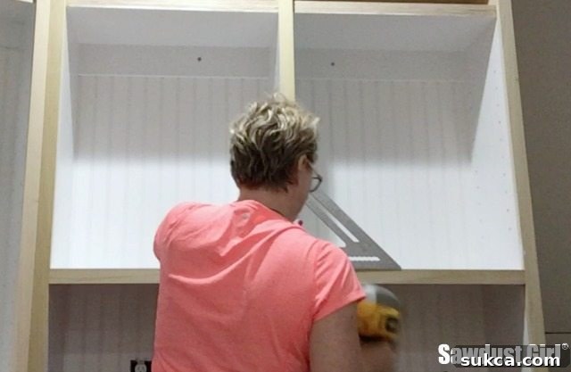 Faceframe pieces being installed directly onto the cabinet structure, piece by piece, ensuring precise fit.
