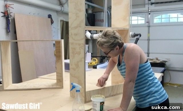 Close-up of cabinet surface with wood patch expertly applied to fill imperfections, showcasing readiness for sanding.