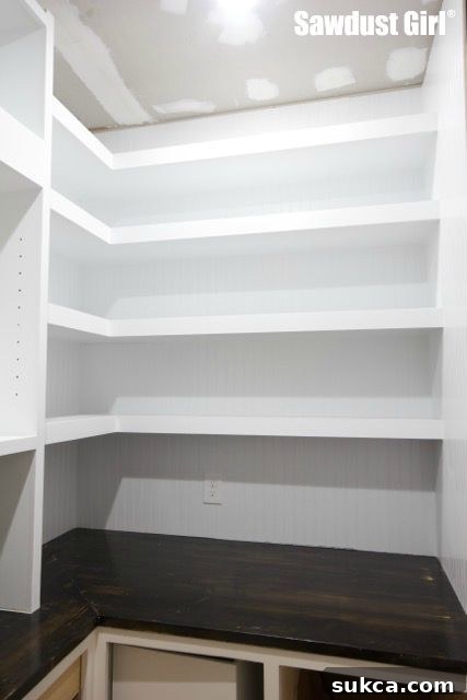 Completed Pantry Floating Shelves Vertical shot of the completed floating shelves, highlighting the clean lines and ample storage space in the pantry.