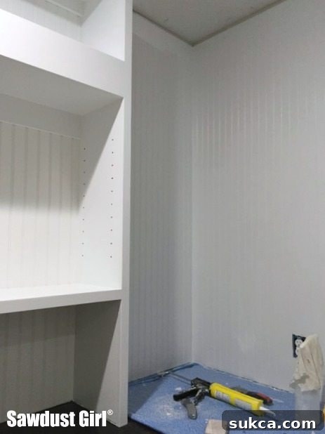 Pantry Wall with Beadboard and Stud Markings Pantry wall prepared with beadboard, showing marked stud locations for floating shelf installation.