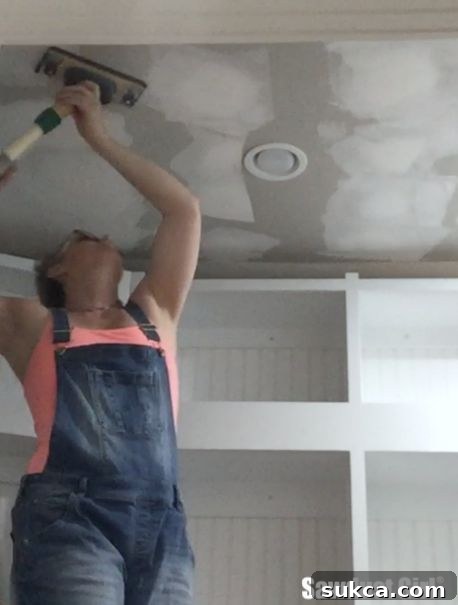 Achieving a dust-free drywall finish Dust free drywall sanding tool in action