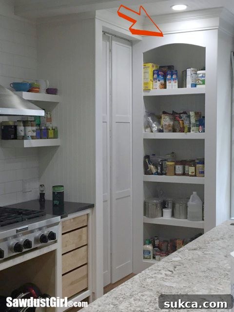 Pantry pocket doors temporarily hung in place, meticulously marking the floor for groove placement.