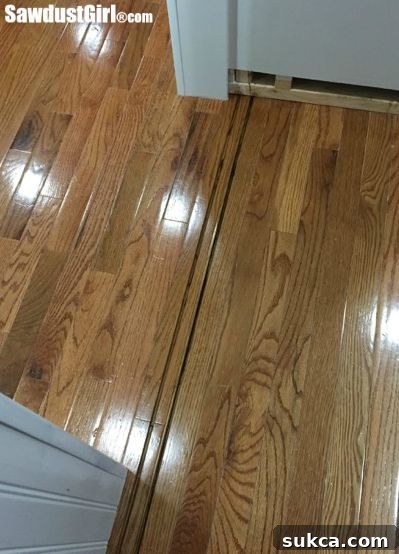 Utilizing a track saw for precise cutting of the floor track for the hidden pantry doors.