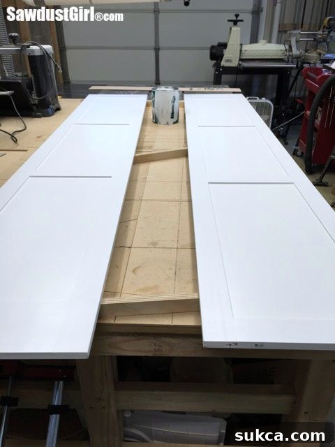 Painting the pantry pocket doors with multiple coats, meticulously sanding between each application.