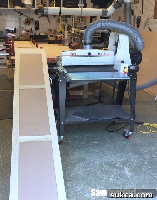 Using a drum sander for the initial, coarse grit sanding of the large pantry doors.