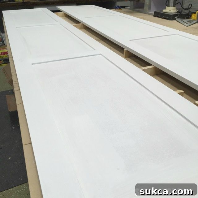 Primed pantry pocket doors, now fully prepared and ready for the final paint coats.