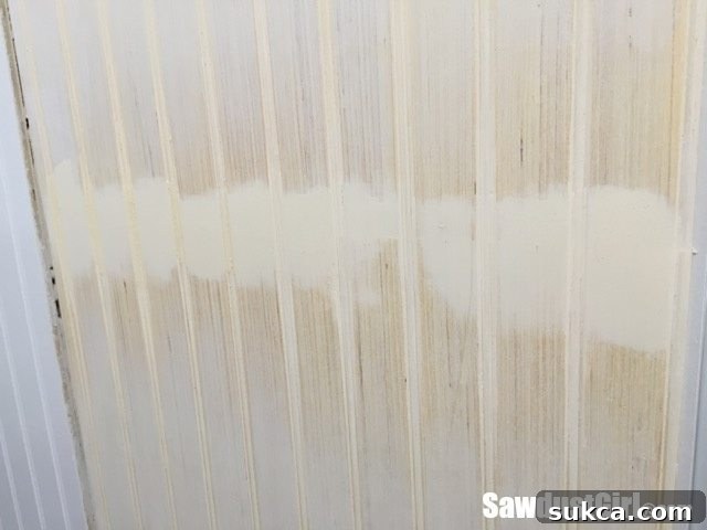 Inspecting a horizontally hidden seam in beadboard paneling.