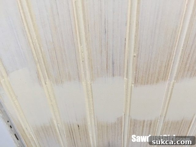 Sanding the flat face of beadboard panels to hide seams.