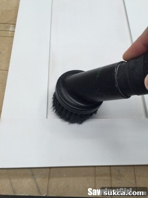 Final Prep Clean-up Final light sanding and cleaning of cabinet doors before the topcoat application, ensuring a pristine surface