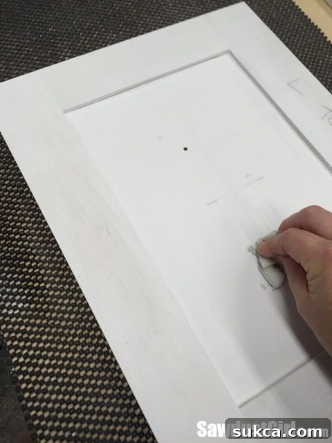 Magic Eraser in Action Magic eraser effectively removing pencil marks from a cabinet door, demonstrating a clean surface prep