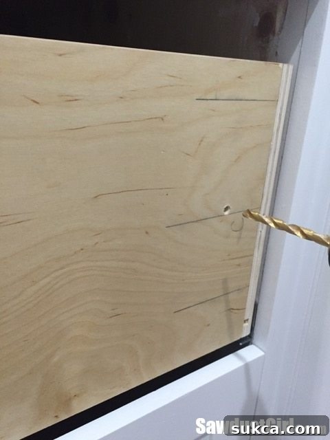 Drilling holes into the drawer box for applied front adjustment screws