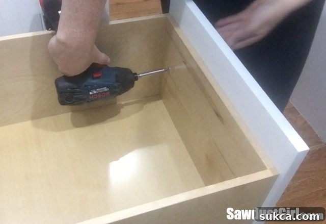 Securing applied drawer front from the inside of the drawer box