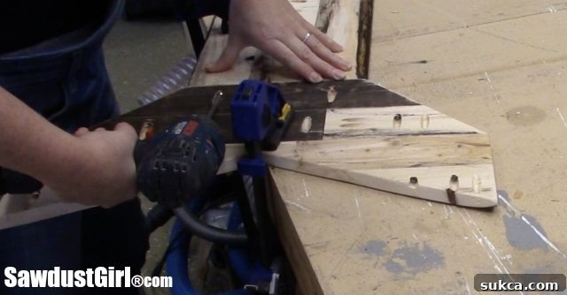 Sanding Arrow Tail Sanding the edges of the pallet wood arrow tail for a smooth finish