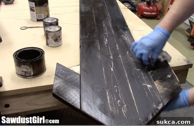 Custom Gel Stain on Wood Arrow Applying a custom-mixed gel stain to the large pallet wood arrow