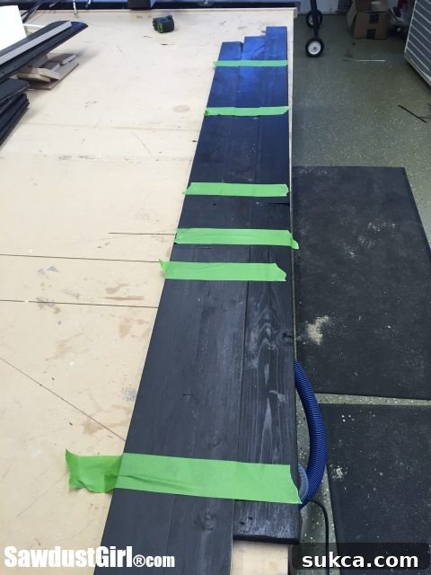 Aligning Pallet Wood Boards Using painter's tape to align pallet wood planks for arrow assembly
