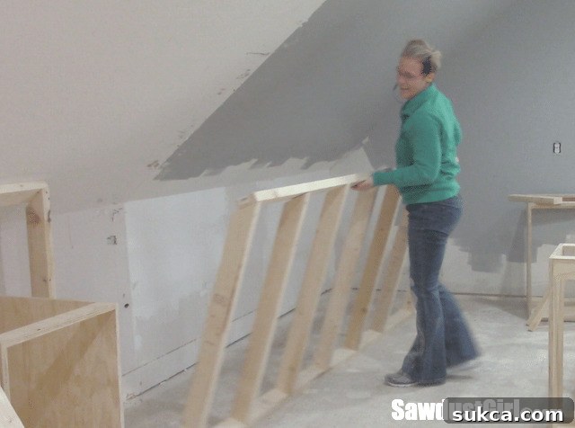 Angled Ceiling Integration Close-up of the completed false wall meeting the angled ceiling, ready for finishing