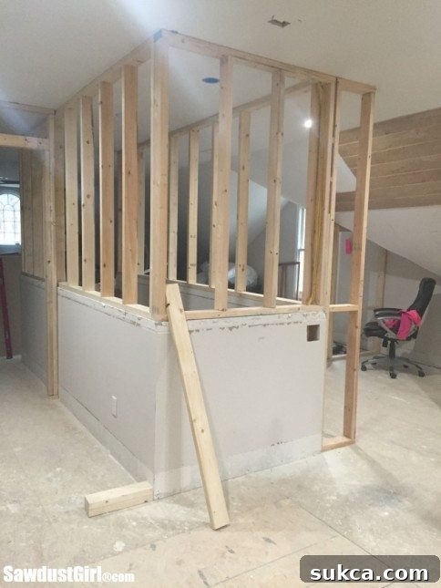 Detailed view of extended stairway wall in a loft, showcasing the creation of new functional areas and storage potential.